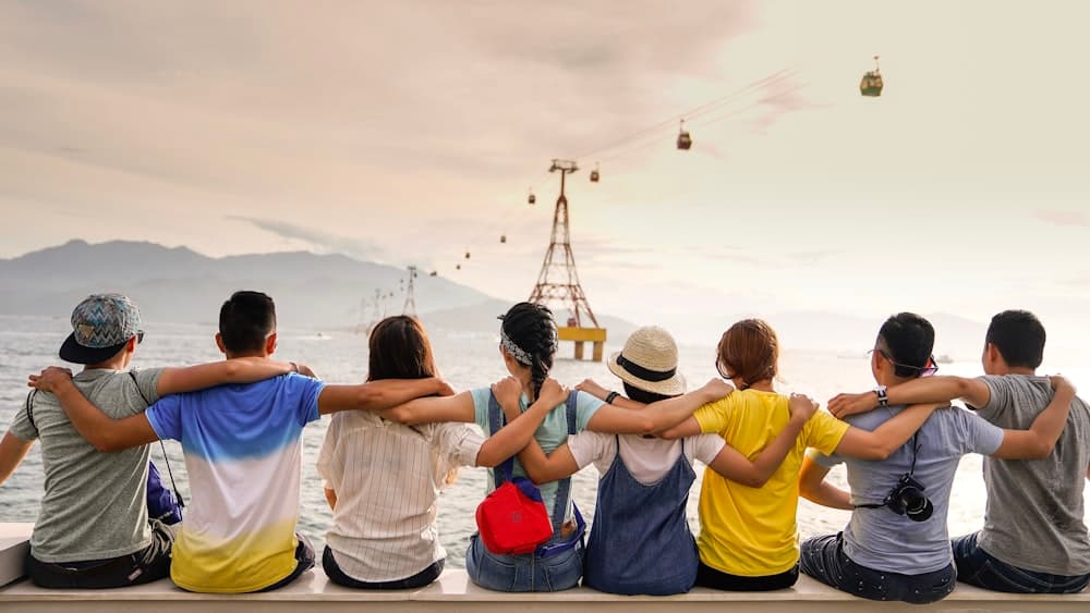Friends gathered together looking out at the sea